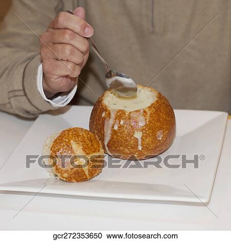 Mid section view of a man eating soup from a bread bowl View Large Photo Image Stock Image - Mid section view of a man eating soup from a bread bowl. Fotosearch