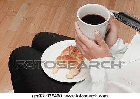 Mid section view of a person holding a coffee cup View Large Photo Image Stock Image - Mid section view of a person holding a coffee cup. Fotosearch