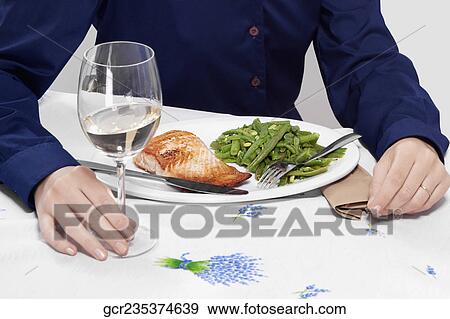 Mid section view of a woman having lunch View Large Photo Image Stock Photo - Mid section view of a woman having lunch. Fotosearch