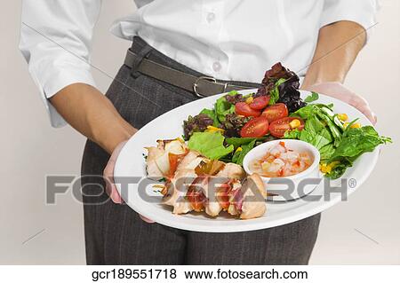 Mid section view of a woman holding a platter of shish kebabs View Large Photo Image Stock Photo - Mid section view of a woman holding a platter of shish kebabs. Fotosearch