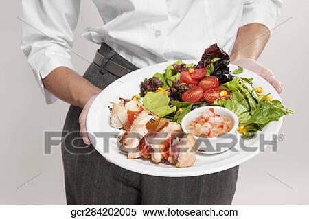 Mid section view of a woman holding a platter of shish kebabs View Large Photo Image Stock Photography - Mid section view of a woman holding a platter of shish kebabs. Fotosearch