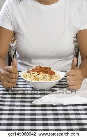 Mid section view of a woman with a bowl of spaghetti View Large Photo Image Stock Image - Mid section view of a woman with a bowl of spaghetti. Fotosearch