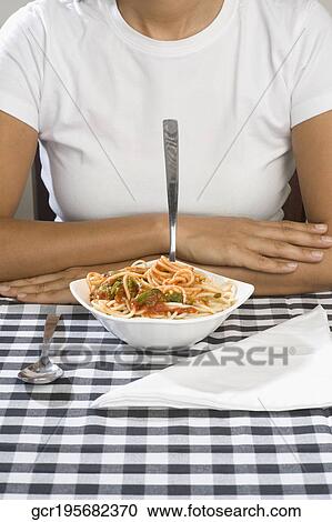 Mid section view of a woman with a bowl of spaghetti View Large Photo Image Stock Image - Mid section view of a woman with a bowl of spaghetti. Fotosearch