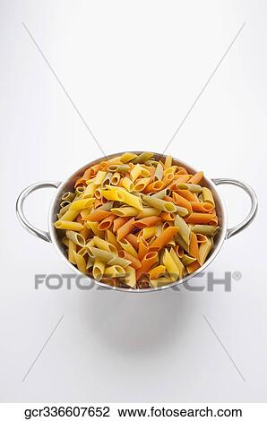 Multi colored rigatoni pasta in a strainer View Large Photo Image Stock Image - Multi colored rigatoni pasta in a strainer. Fotosearch