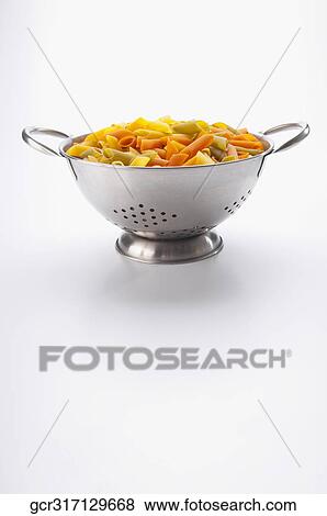 Stock Photo - Multi colored rigatoni pasta in a strainer. Fotosearch