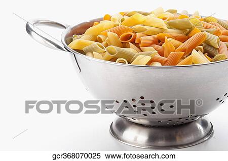 Stock Photography - Multi colored rigatoni pasta in a strainer. Fotosearch
