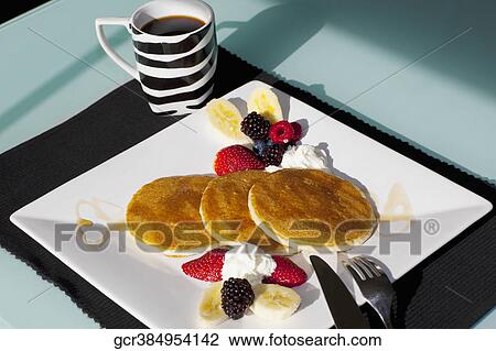Stock Image - Pancakes with fresh fruits. Fotosearch