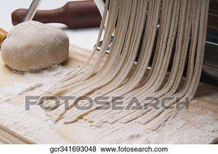 Pasta being cut with a pasta maker View Large Photo Image Stock Photo - Pasta being cut with a pasta maker. Fotosearch
