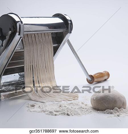 Pasta maker making spaghetti View Large Photo Image Stock Photo - Pasta maker making spaghetti. Fotosearch