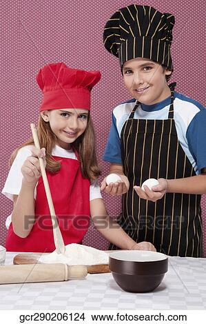 Portrait of a boy and a girl preparing food together View Large Photo Image Picture - Portrait of a boy and a girl preparing food together. Fotosearch