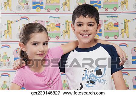 Stock Photo - Portrait of a boy and girl smiling with arm around. Fotosearch