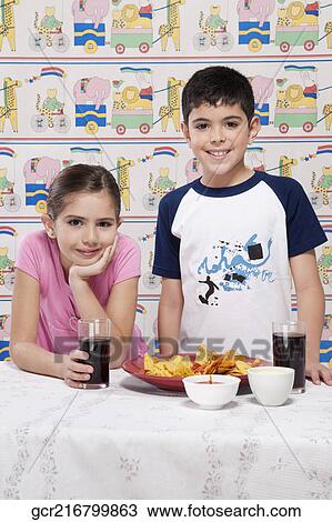 Portrait of a boy and girl with a platter of nachos View Large Photo Image Stock Image - Portrait of a boy and girl with a platter of nachos. Fotosearch