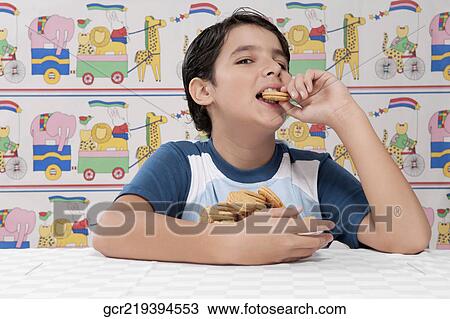 Portrait of a boy eating a cookie View Large Photo Image Stock Image - Portrait of a boy eating a cookie. Fotosearch