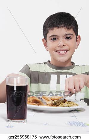 Portrait of a boy having lunch View Large Photo Image Stock Photography - Portrait of a boy having lunch. Fotosearch