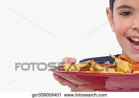 Portrait of a boy holding a platter of nachos View Large Photo Image Stock Image - Portrait of a boy holding a platter of nachos. Fotosearch