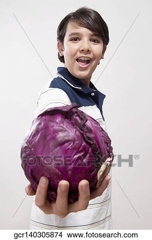 Portrait of a boy showing a red cabbage View Large Photo Image Picture - Portrait of a boy showing a red cabbage. Fotosearch