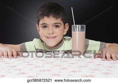 Portrait of a boy with a glass of chocolate milkshake View Large Photo Image Stock Image - Portrait of a boy with a glass of chocolate milkshake. Fotosearch