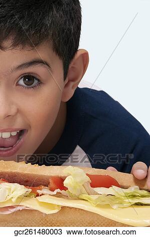 Portrait of a boy with a submarine sandwich View Large Photo Image Stock Image - Portrait of a boy with a submarine sandwich. Fotosearch