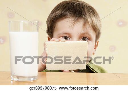 Portrait of a boy with a white chocolate bar and a glass of milk View Large Photo Image Stock Photography - Portrait of a boy with a white chocolate bar and a glass of milk. Fotosearch