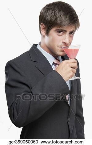 Stock Image - Portrait of a businessman drinking a cocktail. Fotosearch