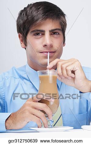 Portrait of a businessman drinking a milkshake with a straw View Large Photo Image Stock Photo - Portrait of a businessman drinking a milkshake with a straw. Fotosearch