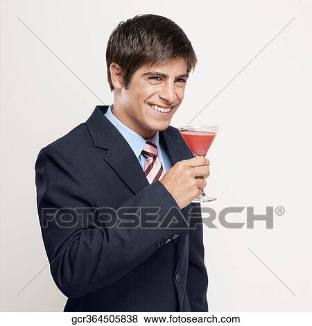 Portrait of a businessman drinking a cocktail View Large Photo Image Stock Photo - Portrait of a businessman drinking a cocktail. Fotosearch