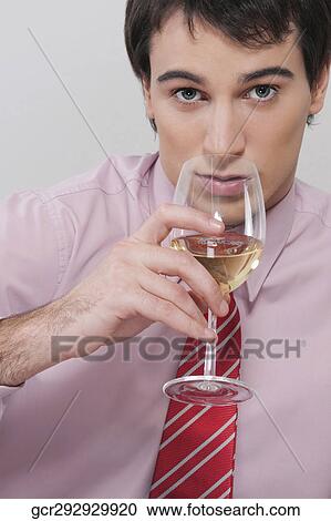 Portrait of a businessman drinking wine View Large Photo Image Stock Image - Portrait of a businessman drinking wine. Fotosearch