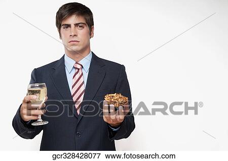 Portrait of a businessman holding a glass of wine and a tart View Large Photo Image Stock Photo - Portrait of a businessman holding a glass of wine and a tart. Fotosearch