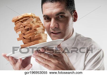 Portrait of a businessman holding sliced breads on a plate View Large Photo Image Stock Photography - Portrait of a businessman holding sliced breads on a plate. Fotosearch