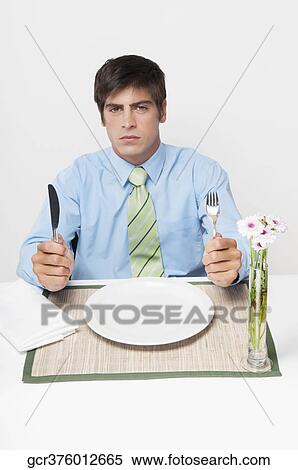 Portrait of a businessman waiting for dinner View Large Photo Image Stock Photography - Portrait of a businessman waiting for dinner. Fotosearch