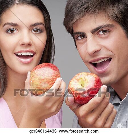 Portrait of a couple eating apples View Large Photo Image Stock Image - Portrait of a couple eating apples. Fotosearch