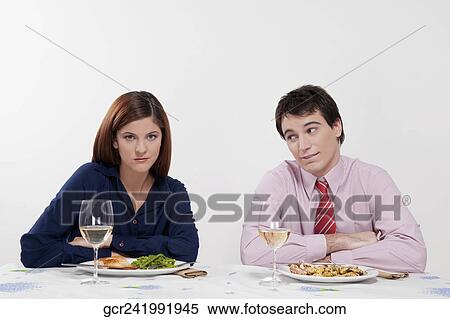 Portrait of a couple sulking at the dinner table View Large Photo Image Stock Photography - Portrait of a couple sulking at the dinner table. Fotosearch