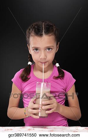 Portrait of a girl drinking chocolate milkshake View Large Photo Image Stock Image - Portrait of a girl drinking chocolate milkshake. Fotosearch