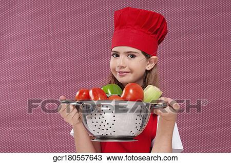 Portrait of a girl holding a colander full of fresh vegetables View Large Photo Image Stock Image - Portrait of a girl holding a colander full of fresh vegetables. Fotosearch