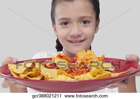 Portrait of a girl holding a platter of nachos View Large Photo Image Stock Image - Portrait of a girl holding a platter of nachos. Fotosearch