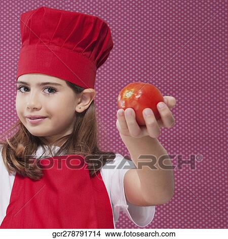 Portrait of a girl holding a tomato View Large Photo Image Picture - Portrait of a girl holding a tomato. Fotosearch