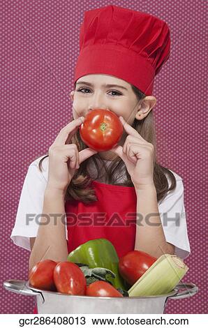 Portrait of a girl holding a tomato View Large Photo Image Stock Image - Portrait of a girl holding a tomato. Fotosearch
