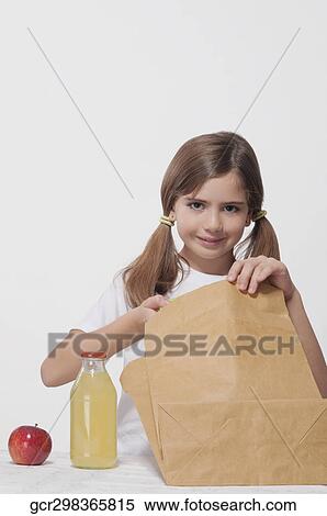 Portrait of a girl packing lunch for school View Large Photo Image Stock Photography - Portrait of a girl packing lunch for school. Fotosearch