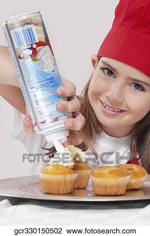 Portrait of a girl putting whipped cream on cupcakes View Large Photo Image Stock Image - Portrait of a girl putting whipped cream on cupcakes. Fotosearch