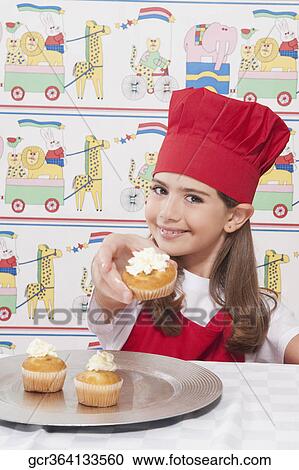Portrait of a girl putting whipped cream on cupcakes View Large Photo Image Stock Image - Portrait of a girl putting whipped cream on cupcakes. Fotosearch