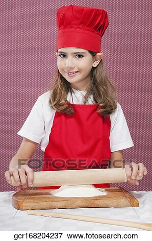 Portrait of a girl rolling out dough View Large Photo Image Stock Photo - Portrait of a girl rolling out dough. Fotosearch