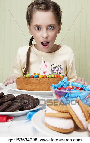 Portrait of a girl with a birthday cake View Large Photo Image Stock Photo - Portrait of a girl with a birthday cake. Fotosearch