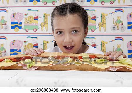 Stock Photo - Portrait of a girl with a submarine sandwich. Fotosearch