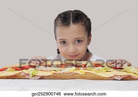 Portrait of a girl with a submarine sandwich View Large Photo Image Stock Photograph - Portrait of a girl with a submarine sandwich. Fotosearch