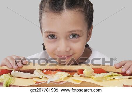 Portrait of a girl with a submarine sandwich View Large Photo Image Stock Photography - Portrait of a girl with a submarine sandwich. Fotosearch