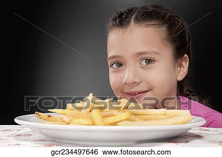 Portrait of a girl with French fries View Large Photo Image Stock Photograph - Portrait of a girl with French fries. Fotosearch