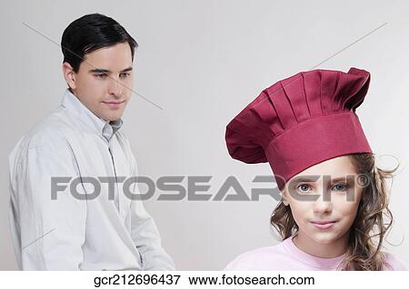 Portrait of a girl with her father in the background View Large Photo Image Stock Photo - Portrait of a girl with her father in the background. Fotosearch