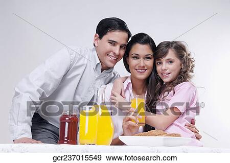 Portrait of a happy family at a breakfast table View Large Photo Image Stock Photo - Portrait of a happy family at a breakfast table. Fotosearch