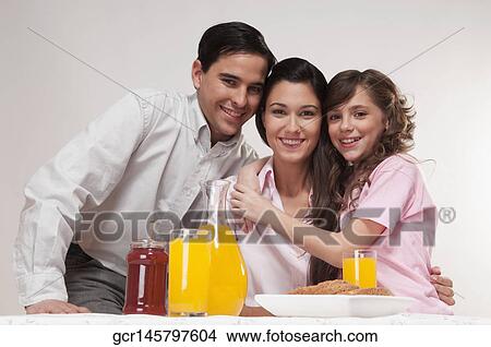 Picture - Portrait of a happy family at the breakfast table. Fotosearch