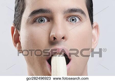 Portrait of a man eating a banana View Large Photo Image Stock Image - Portrait of a man eating a banana. Fotosearch
